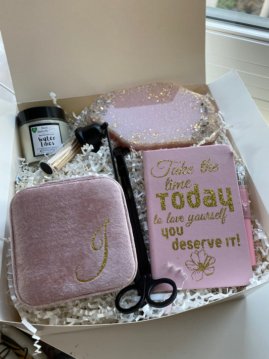 Blushing Radiance wellness travel bundle with custom resin coaster hand-poured scented candle travel jewelry case travel journal with "Take the time today to love yourself you deserve it" printed includes black metal candle kit and matches inside glass bottle