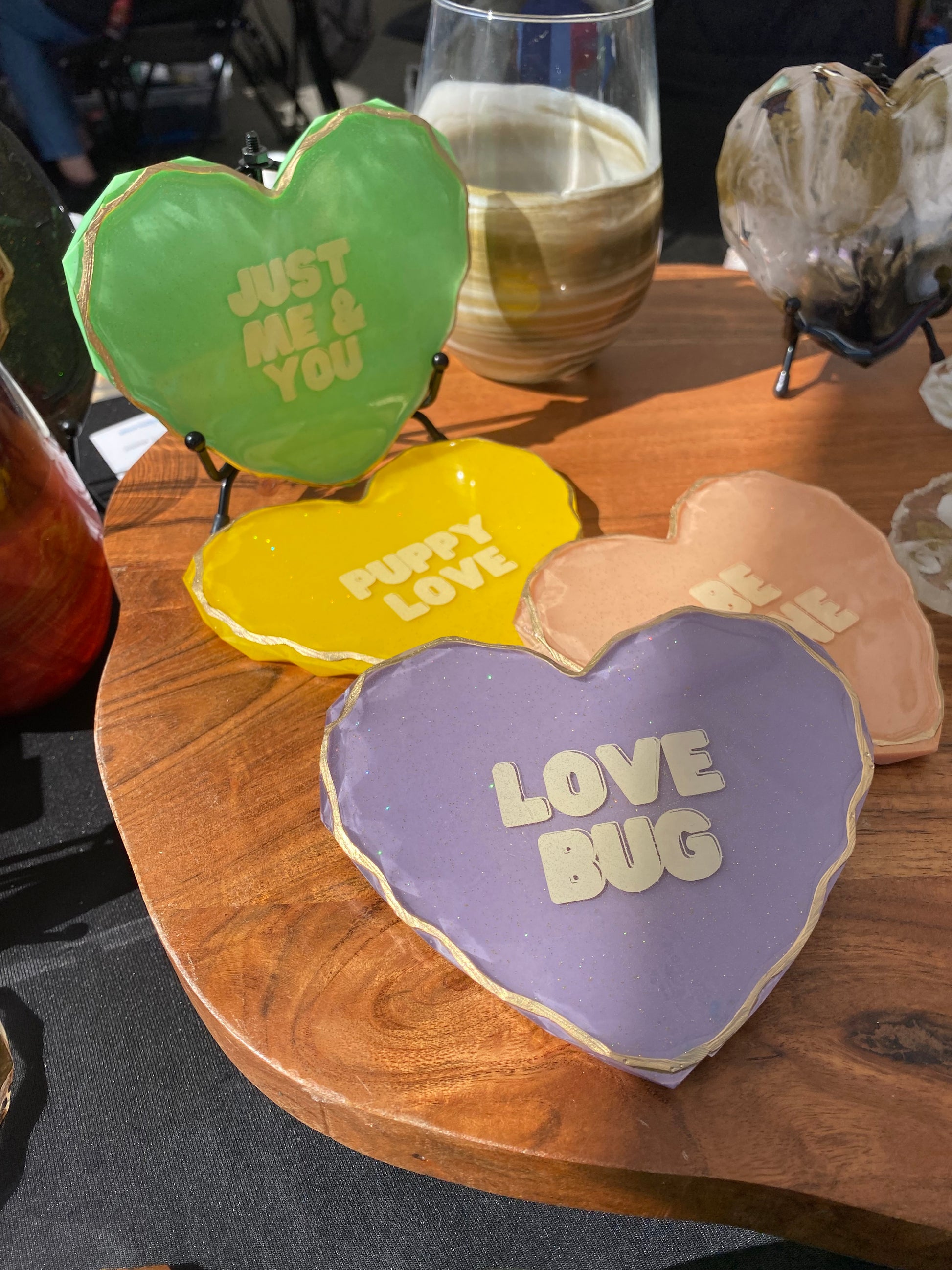 Resin coaster hearts resembling conversation heart candy including pastel colors with light glitter and custom message on each